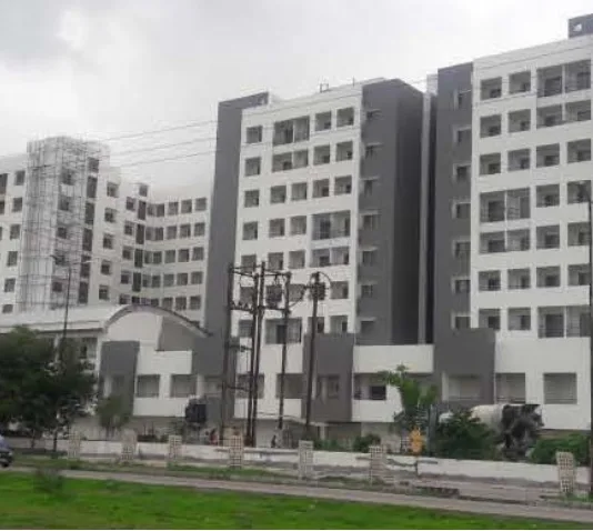 The Scheme No. 136 towers from the road, during construction